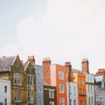 assorted-color concrete houses under white clouds during daytime